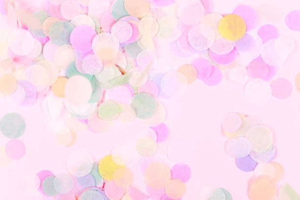 istock Vibrant confetti on pastel pink background 1023564390