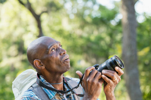 istock Senior African-American man hiking, with camera 1023569620