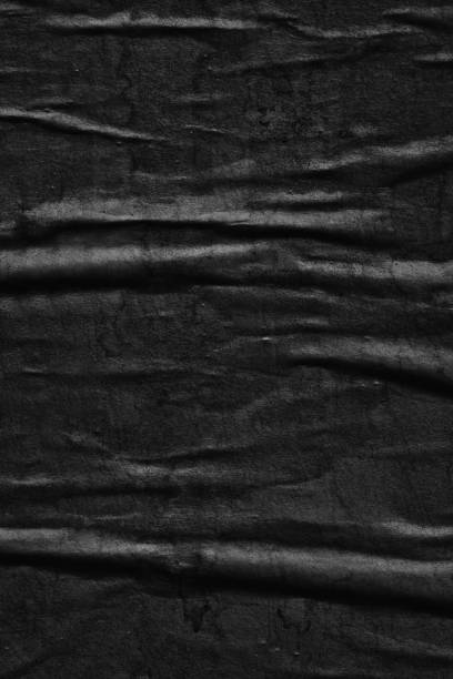istock Dark black blank paper background creased crumpled surface / Old torn ripped posters scary grunge textures 1023573540