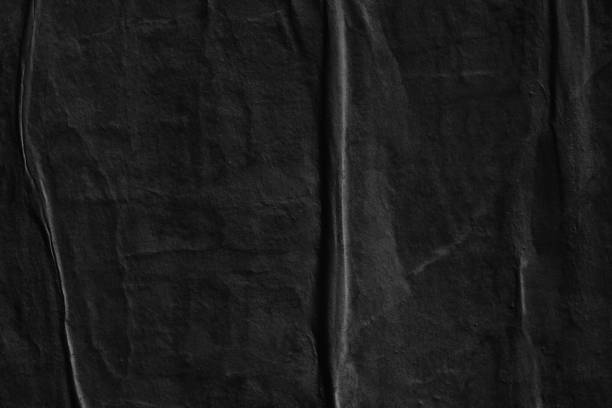 istock Dark black blank paper background creased crumpled surface / Old torn ripped posters scary grunge textures 1023576014