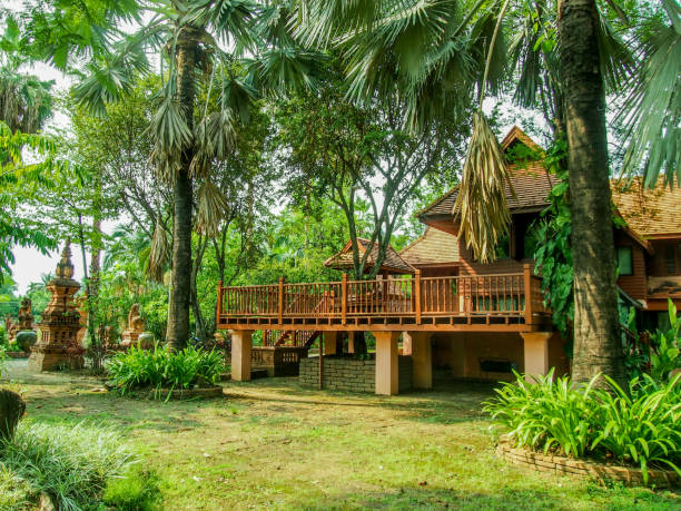 istock Green grass and tree in a beautiful park and buildings 1023579704