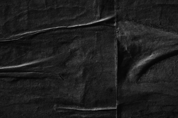 istock Dark black blank paper background creased crumpled surface / Old torn ripped posters scary grunge textures 1023579768