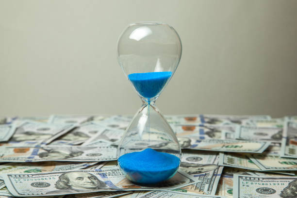 istock Hourglass and money dollars banknotes 1023582394