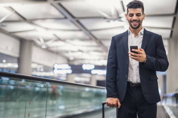 istock Business executive with mobile phone at airport 1023582462