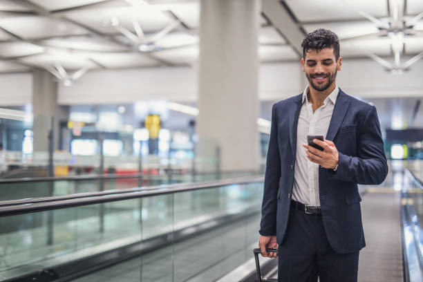 istock Business executive with mobile phone at airport 1023582780