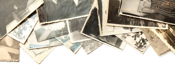 istock Stack old photos isolated on white background. Postcard rumpled and dirty vintage 1023582996