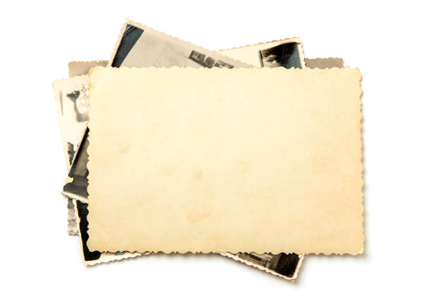 istock Stack old photos isolated on white background. Mock-up blank paper 1023583006