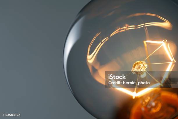 Close Up Glowing Light Bulb Stock Photo - Download Image Now - Light Bulb, Close-up, Inspiration