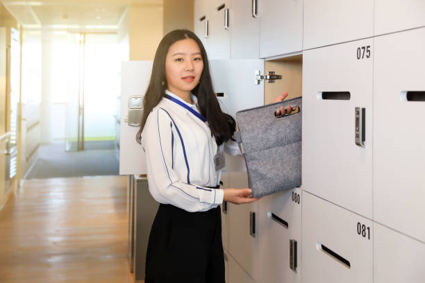istock Beautiful white-collar workers store items in lockers 1023588398
