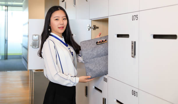 istock Beautiful white-collar workers store items in lockers 1023588404