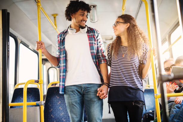 istock Young beautiful couple looking at each other while leaving the bus. 1023588772