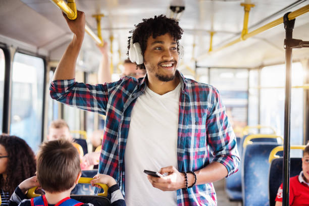 young afro-american man with headset on his head is looking away while riding in a bus. - dutch ethnicity imagens e fotografias de stock