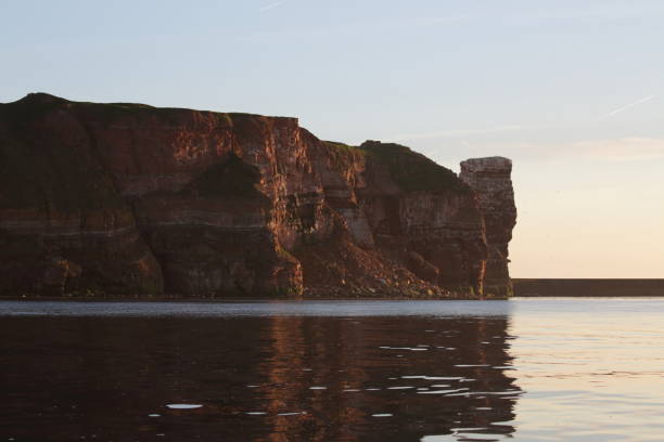 istock Sunset on the rocky coast, sunset on Helgoland in Germany 1023589342