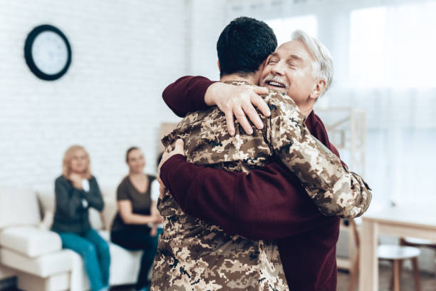 A Man Returns From The Military. Family Meeting. A Man Returns From The Military Service. Family Meeting. Leaving From War. Embrace With Family. Camouflage Uniform. Dad Hanging. Feelings Showing. Patriotic Comeback. Soldier Emotion. proud army mom stock pictures, royalty-free photos & images