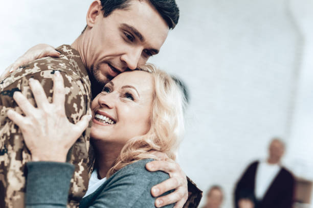 A Man Returns From The Military. Family Meeting. A Man Returns From The Military Service. Family Meeting. Leaving From War. Embrace With Family. Camouflage Uniform. Mom Hanging. Feelings Showing. Patriotic Comeback. Soldier Emotion. proud army mom stock pictures, royalty-free photos & images