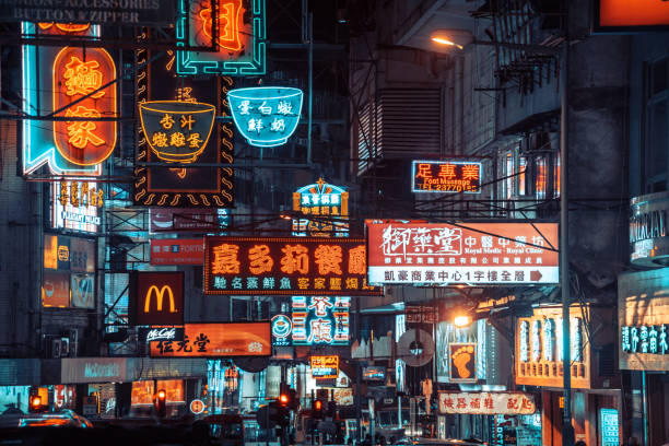 Colorful neon night street road in Hongkong People stroll around colorful street in Mong Kok district, Hongkong. Colorful neon signs in the background mong kok stock pictures, royalty-free photos & images