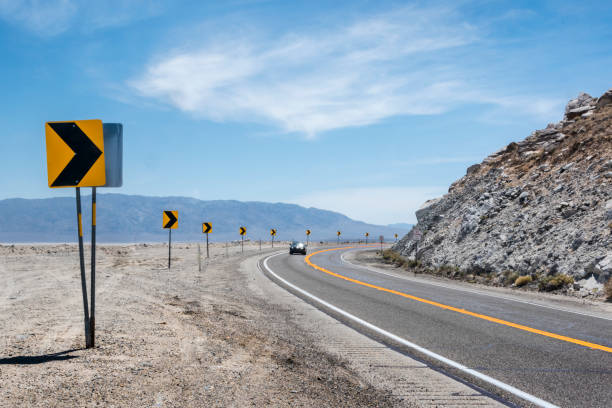 istock Sharp curve warning signs on the road, Trona, CA 1023601482