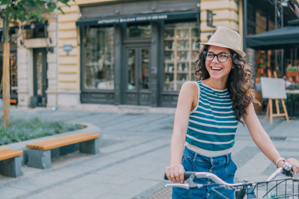 istock Woman with summer hat smiling when sitting on bicycle 1023601584