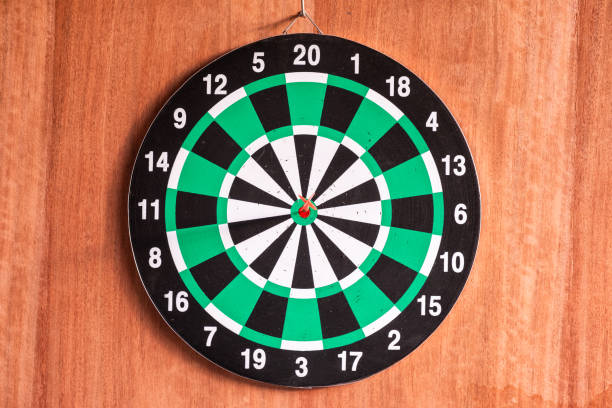 istock Dart arrow in bullseye target on dartboard 1023603018