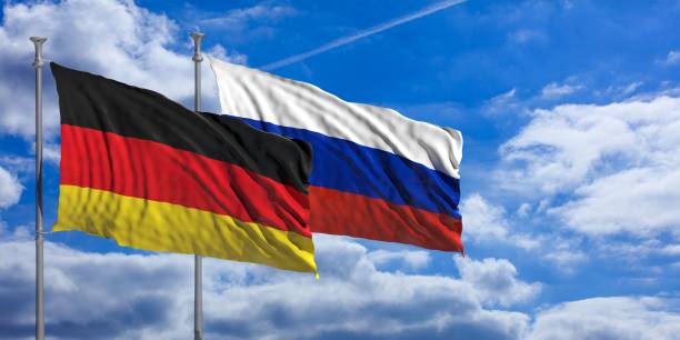 istock Russia and  Germany waving flags on blue sky. 3d illustration 1023603266