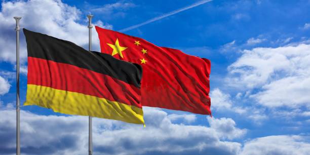 istock China and  Germany waving flags on blue sky. 3d illustration 1023604044