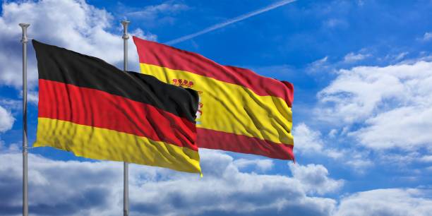 istock Spain and  Germany waving flags on blue sky. 3d illustration 1023605310