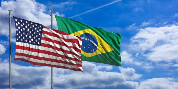 istock Brasil and America waving flags on blue sky. 3d illustration 1023605326