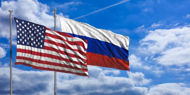 istock Russia and America waving flags on blue sky. 3d illustration 1023607430
