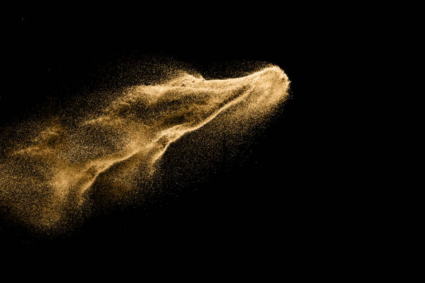 istock Dry river sand explosion. Golden colored sand splash against dark background. 1023607724