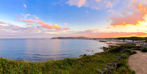 Beautiful sunset panorama of Douglas Bay Isle of Man Beautiful sunset panorama of Douglas Bay Isle of Man British Isles viewed from a popular viewing point at Onchan sound port stock pictures, royalty-free photos & images