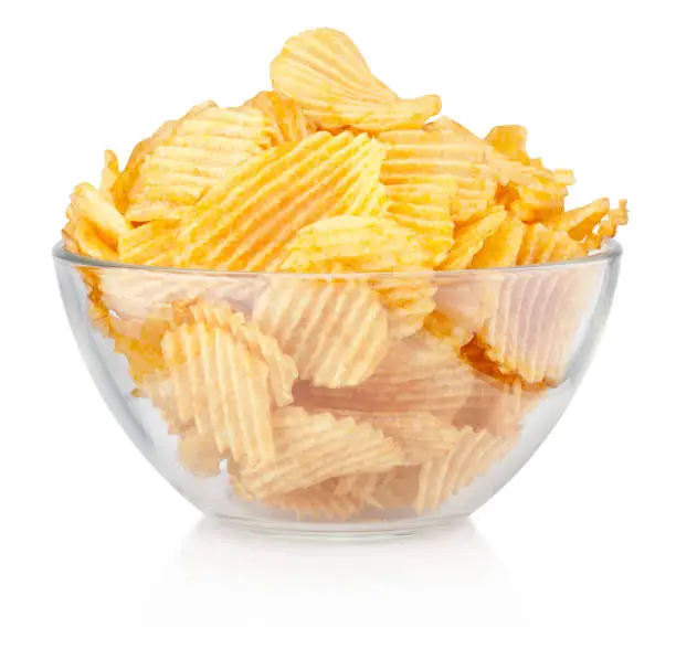 Photo of Crinkle cut potato chips in bowl isolated on a white background