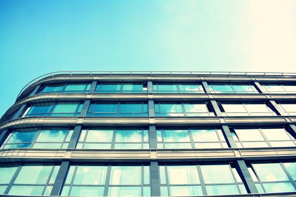 istock Modern office building on a clear sky background. Retro stylized colorful tonal filter effect 1023617214