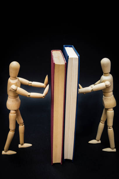 istock Two mannequins holding two books 1023617452