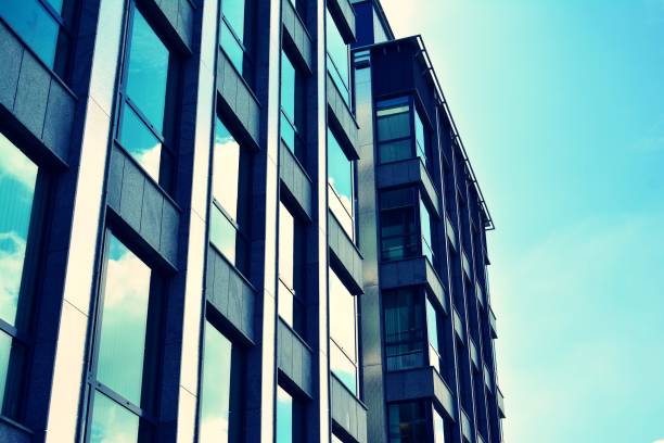 istock Modern office building on a clear sky background. Retro stylized colorful tonal filter effect 1023617944