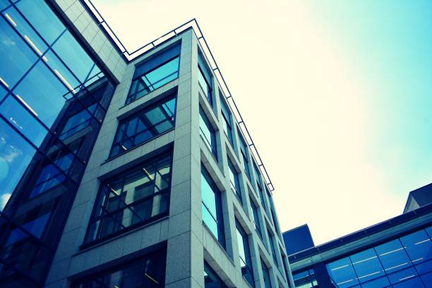 istock Modern office building on a clear sky background. Retro stylized colorful tonal filter effect 1023618156