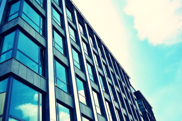 istock Modern office building on a clear sky background. Retro stylized colorful tonal filter effect 1023622678