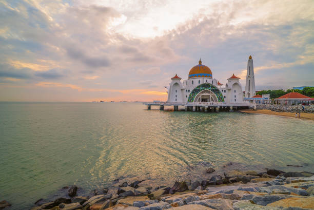 sunset over the majestic mosque, Malacca Straits Floating Mosque (Masjid Selat Melaka). stock photo