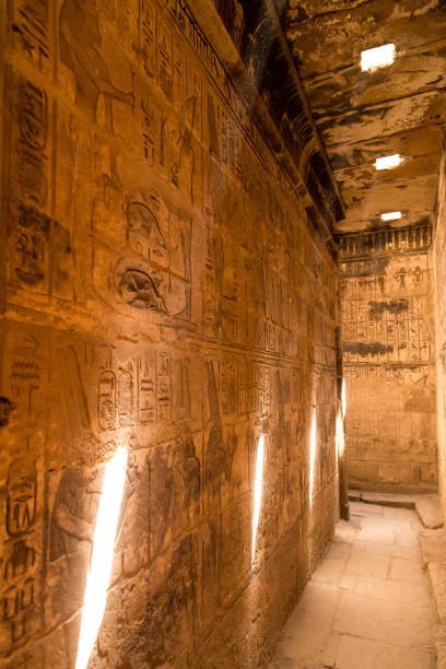 istock stone wall with Egyptian carving figures and hieroglyphs, Luxor, Egypt. 1023629378