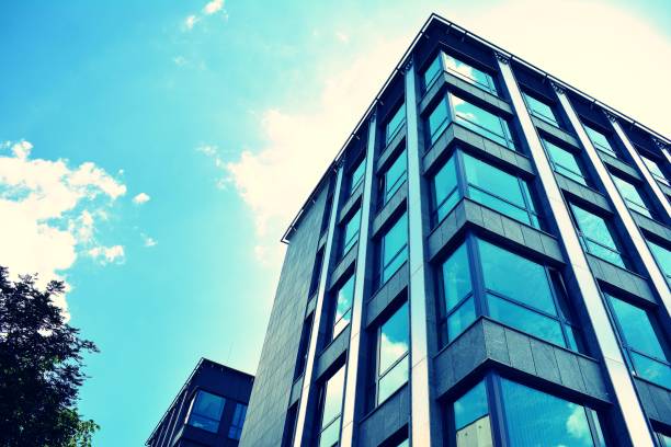 istock Modern office building on a clear sky background. Retro stylized colorful tonal filter effect 1023630826