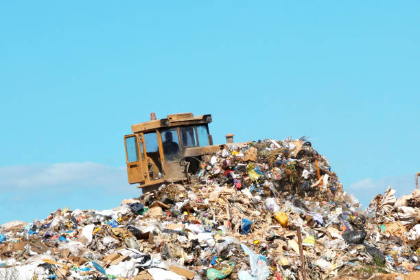 istock Bulldozer moving garbage at the rubbish dump site 1023634638