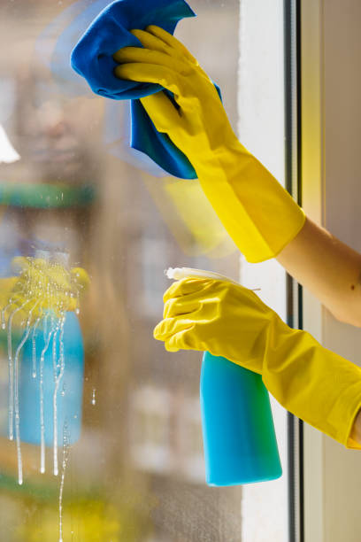 istock Gloved hand cleaning window rag and spray 1023635778