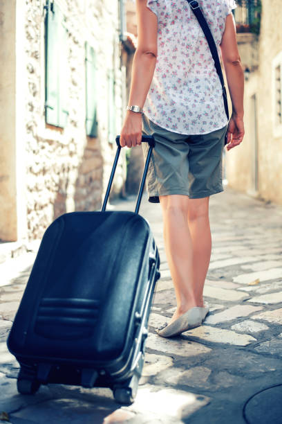 istock Tourist walking with suitcase on the street 1023639166