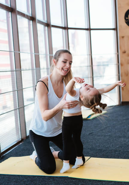 istock Mom and daughter together perform different exercises 1023646424