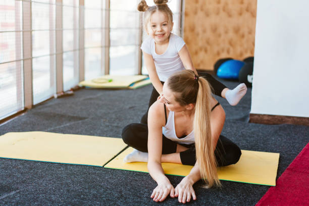 istock A small daughter sits at her mother's back 1023648642