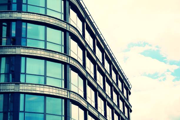 istock Modern office building on a clear sky background. Retro stylized colorful tonal filter effect 1023652804