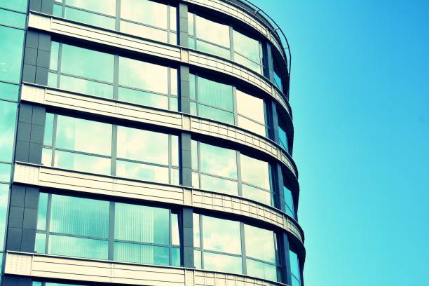 istock Modern office building on a clear sky background. Retro stylized colorful tonal filter effect 1023653440
