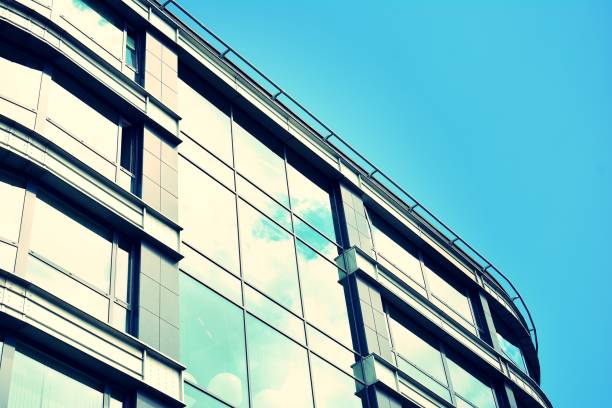 istock Modern office building on a clear sky background. Retro stylized colorful tonal filter effect 1023658344