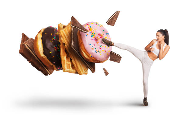istock Fit young woman fighting off sweets and candy 1023666022