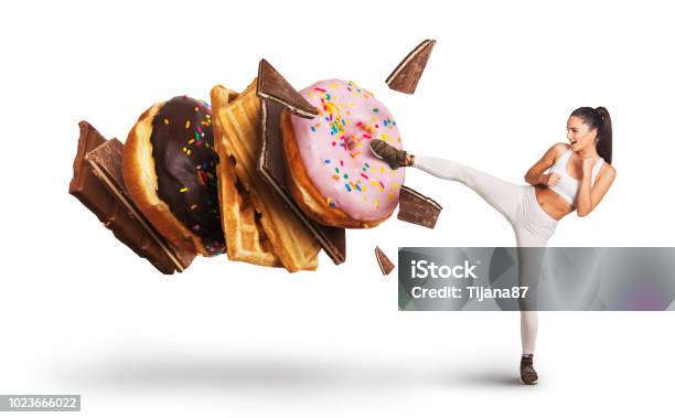 Fit Young Woman Fighting Off Sweets And Candy Stock Photo - Download Image Now - Sugar - Food, Craving, Addiction