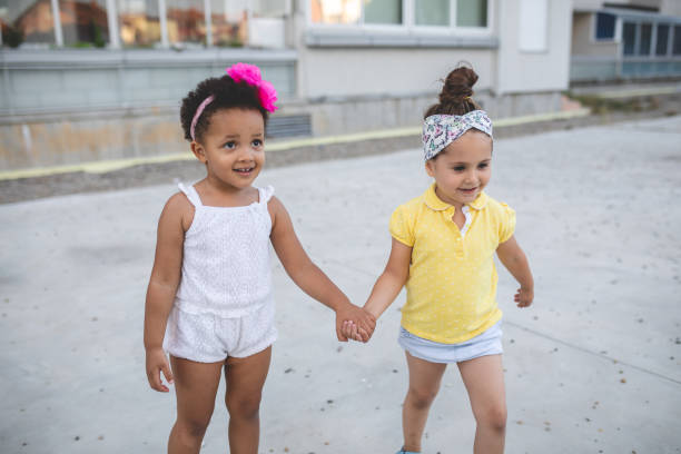 Cute and lovely mixed race siblings enjoying their time together in a city public park.